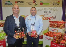 Mac Riggan and Darrin Carpenter with Chelan Fresh show a pouch bag with Koru apples and a container of Rockit apples.